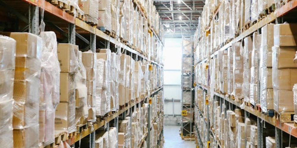 Spacious warehouse aisles lined with shelves stacked with boxes and packaging.